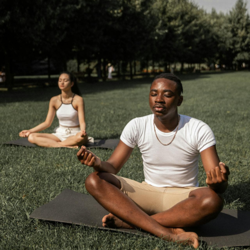 Multiethnic couple meditating in nature